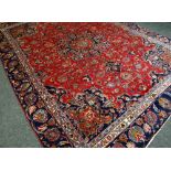 A RED GROUND PERSIAN MARSHAD CARPET with traditional medallion design, 350 x 256cms