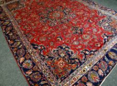 A RED GROUND PERSIAN MARSHAD CARPET with traditional medallion design, 350 x 256cms