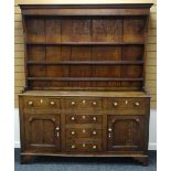 A NINETEENTH CENTURY NORTH WALES OAK WELSH DRESSER composed of a base with four centre drawers, a