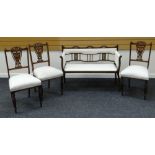 A DELICATE EDWARDIAN INLAID MAHOGANY SETTEE together with three similar but non-matching chairs, all