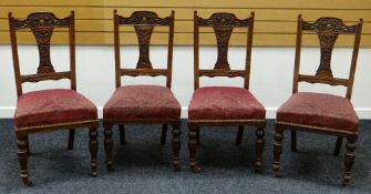 A SET OF FOUR TURN OF THE CENTURY CARVED CHAIRS with stuff over seats on turned supports