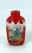 A CHINESE INSIDE-PAINTED GLASS SNUFF BOTTLE with red overlay, 7cms high