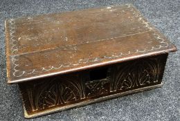 AN EARLY NINETEENTH CENTURY OAK BIBLE BOX having a carved facade initialled W P (for restoration)