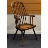 AN ELM WINDSOR-STYLE FARMHOUSE CHAIR having splayed supports & two-stage spindle and hoop back