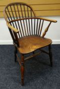 AN ELM WINDSOR ELBOW CHAIR with two-stage spindle & hoop back and having turned supports