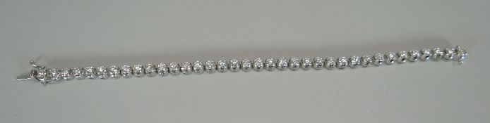 A SPECTACULAR DIAMOND TENNIS BRACELET with 36 round brilliant cut diamonds in an 18ct white gold