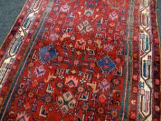 LARGE FULL PILE PERSIAN RED GROUND RUNNER with all over design, 314 x 112cms