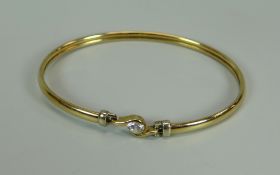 A 9K YELLOW GOLD BANGLE WITH SOLITAIRE DIAMOND