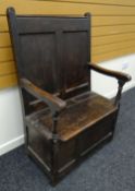 AN EARLY NINETEENTH CENTURY OAK SETTLE of small proportions (reduced) having a box-seat over