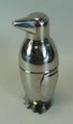 A NOVELTY WHITE METAL COCKTAIL SHAKER in the form of a standing penguin with bow tie, 19cms high (c