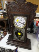 Carved and cased antique table clock