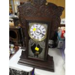 Carved and cased antique table clock