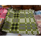 Green ground, grey, black and white geometric patterned Welsh blanket