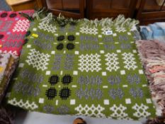 Green ground, grey, black and white geometric patterned Welsh blanket