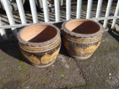 Pair of large amber glazed dragon decorated garden plant pots (outside)