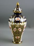 A ROYAL CROWN DERBY VASE of tapered form to a slim base and with a gilt knopped lid, 22 cms high