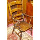 A 19th CENTURY FARMHOUSE ARMCHAIR with ladderback and turned lumbar rail, the swept arms spindle