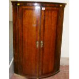 A VICTORIAN OAK & MAHOGANY BOW FRONT WALL HANGING CORNER CUPBOARD with boxwood line stringing