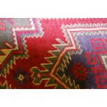 A BALOCHI WOVEN WOOL RUG with traditional stylized pattern on a predominantly green ground, 146 x 91