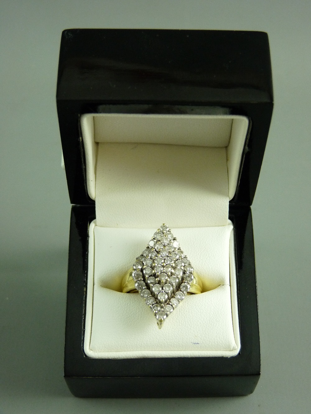AN EIGHTEEN CARAT GOLD DIAMOND DRESS RING having forty two small round cut diamonds in three