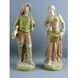 A PAIR OF ROYAL DUX STANDING FIGURES, one of a young fisherman, the other a harvest gathering