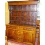 AN EARLY 19th CENTURY NORTH WALES OAK DRESSER, the extended canopy rack with three plate shelves and