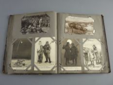 A VINTAGE ALBUM CONTAINING EIGHTY PLUS POSTCARDS & NEEDLEWORK SILKS, mostly First World War