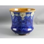 A ROYAL DOULTON STONEWARE JARDINIERE, tube line decorated, stylized rim band on a mottled cobalt