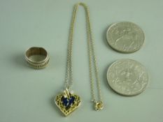 A HEART SHAPED WHITE & YELLOW METAL PENDANT having four floral set oval sapphires and two czs and