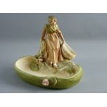 A ROYAL DUX PORCELAIN FIGURAL BOWL of a young girl on a rocky crop holding an open basket, the