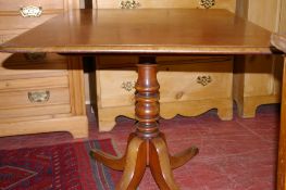 A VICTORIAN MAHOGANY TILT TOP BREAKFAST TABLE, the rectangular top with moulded edge, supported on a