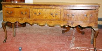 A GEORGE IV OAK SHROPSHIRE DRESSER/SIDEBOARD, the narrow two plank top over an inverted moulding