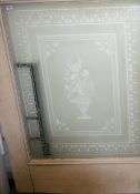 AN ANTIQUE ETCHED GLASS DOOR PANEL showing a central twin handled urn of flowers with twin