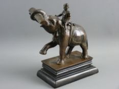 AN INDIAN BRONZE GROUP modelled as a working elephant and rider, the semi-rearing animal carrying
