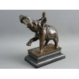 AN INDIAN BRONZE GROUP modelled as a working elephant and rider, the semi-rearing animal carrying