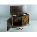 A VINTAGE OAK SMOKER'S CABINET with decorative front moulding and lidded top opening to reveal a