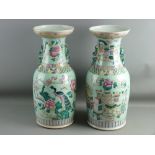 A PAIR OF 19th CENTURY CHINESE CANTON VASES having opposing open decoration of peacocks amongst