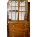 A GEORGE IV MAHOGANY BOOKCASE CHEST, the two door glazed top with eleven pane doors with arched