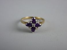 A NINE CARAT GOLD DRESS RING with four floral set oval amethysts and five tiny diamonds, 2.5 grms