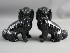 A PAIR OF BLACK JACKFIELD POTTERY TYPE SEATED SPANIELS with open front legs, gilt collars and