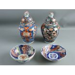 A PAIR OF LATE 19th/EARLY 20th CENTURY IMARI BALUSTER JARS with knopped covers, 20 cms high and