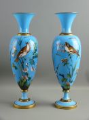 A PAIR OF VICTORIAN BLUE OPAQUE GLASS ENAMEL PAINTED BALUSTER VASES having opposing birds amongst
