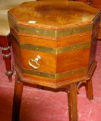 AN OCTAGONAL MAHOGANY BRASS BOUND CELLARETTE with brass ring handles on a base with four reeded