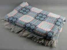 A LARGE VINTAGE WELSH WOOLLEN BLANKET in pink, green and blue tones