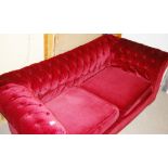 A LATE VICTORIAN/EARLY EDWARDIAN PLUSH BURGUNDY THREE SEATER CHESTERFIELD SETTEE