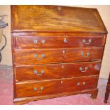 A GEORGIAN MAHOGANY FALL FRONT BUREAU having four long lower drawers on corner bracket feet, the