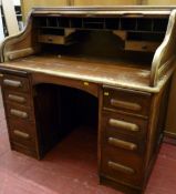 A CIRCA 1920 OAK ROLL TOP DESK, the tambour fall with Bramah type lock and key and an interior