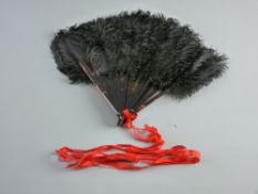 A TORTOISESHELL HANDLED BLACK FEATHER FAN