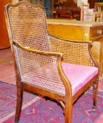 A SMALL MAHOGANY FRAMED BERGERE ELBOW CHAIR