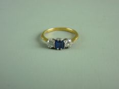 AN EIGHTEEN CARAT GOLD LADY'S DRESS RING having a centre square cut sapphire with two flanking